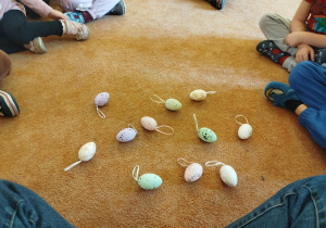 Dzieci oglądają kolorowe pisanki.